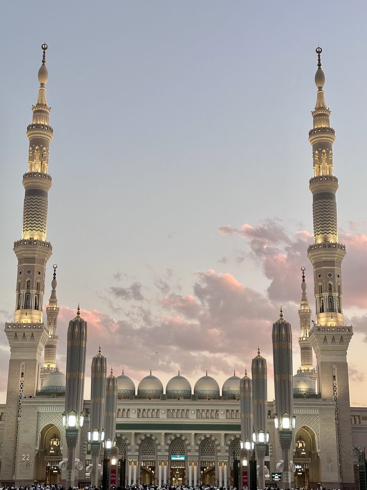Minarets of the Prophet's Mosque at dusk, pink clouds overhead