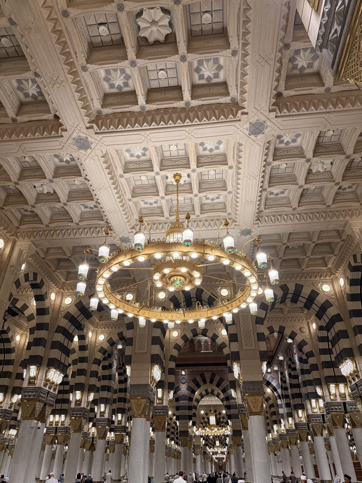Inside the Prophet's Mosque — carved ceilings and great chandeliers