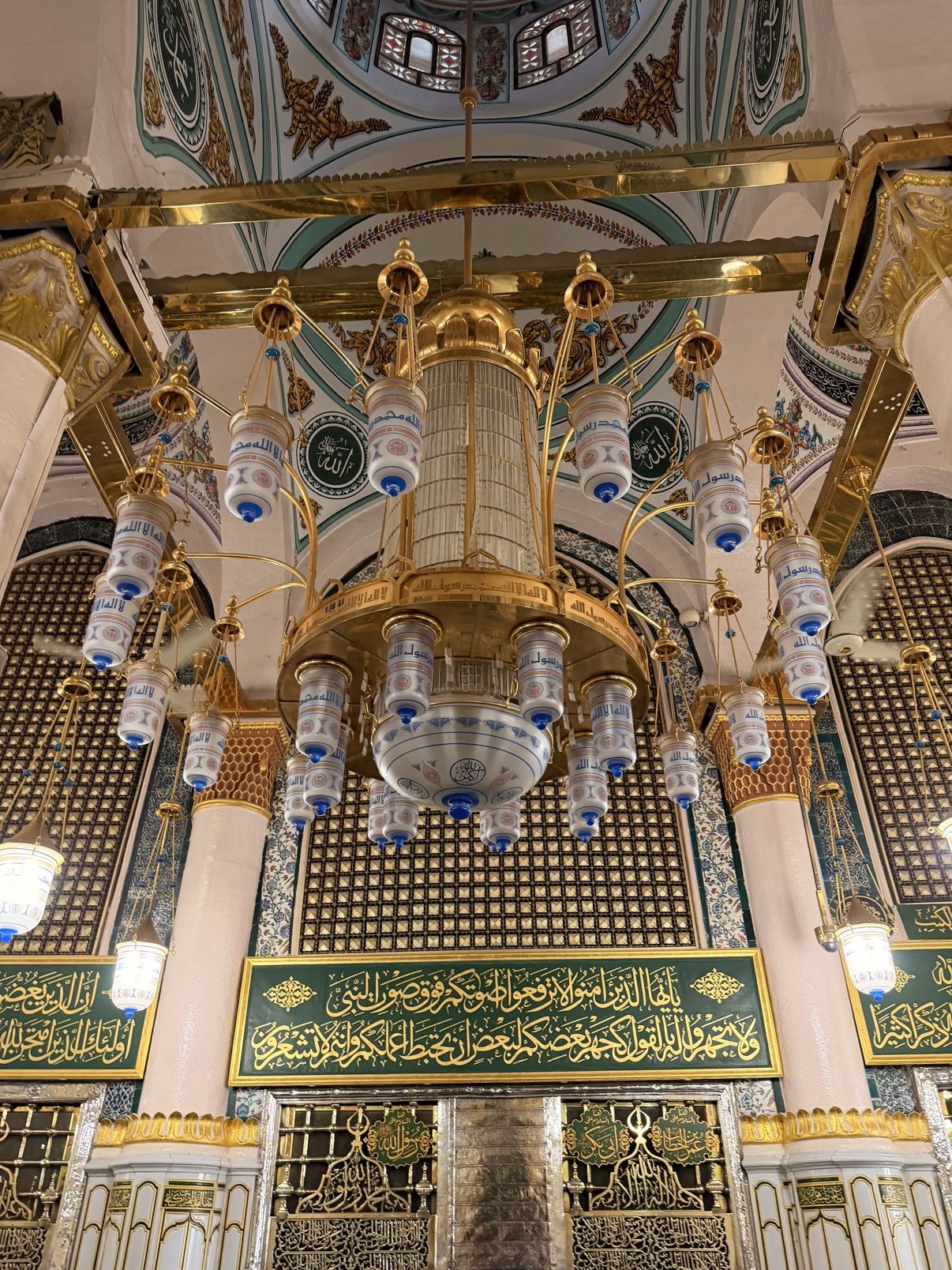 Gilded columns and chandeliers inside the Prophet's Mosque