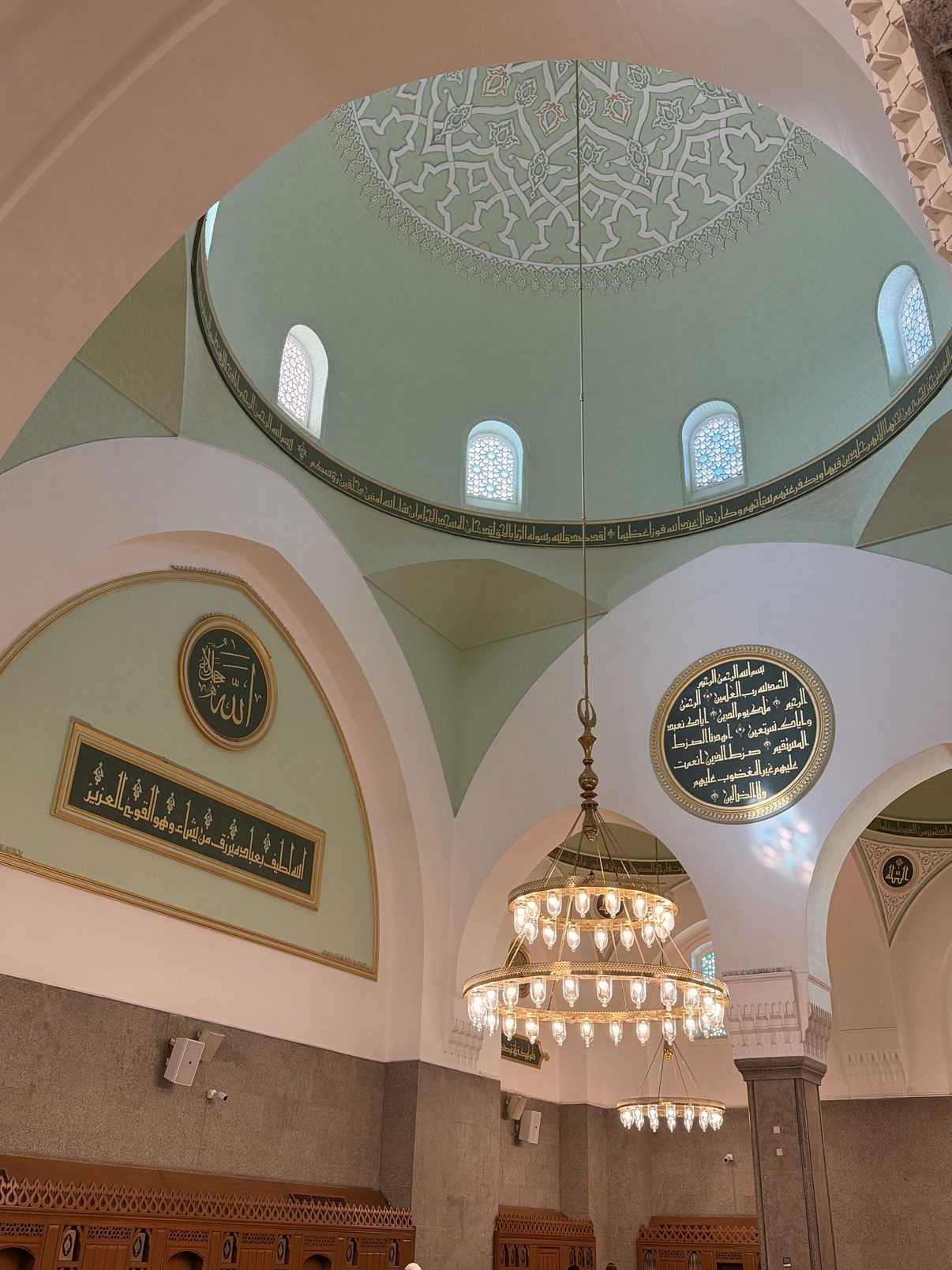 A painted dome and chandelier inside the Prophet's Mosque
