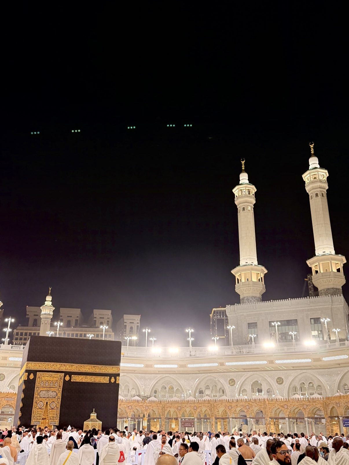 The Prophet's Mosque at night, its facade washed in light