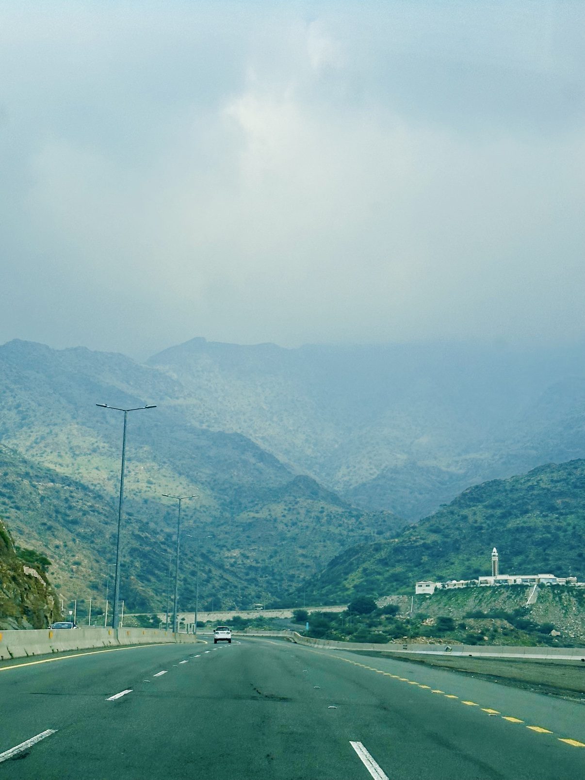 The mountain road to Taif, green slopes under a soft sky