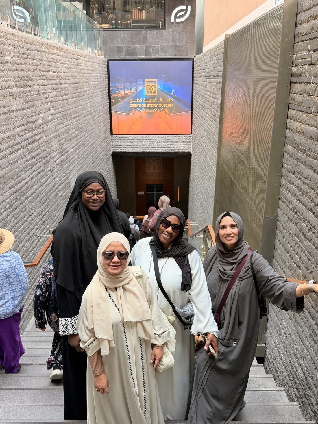 Women of the group on the steps of the Creation Story Museum in Madinah