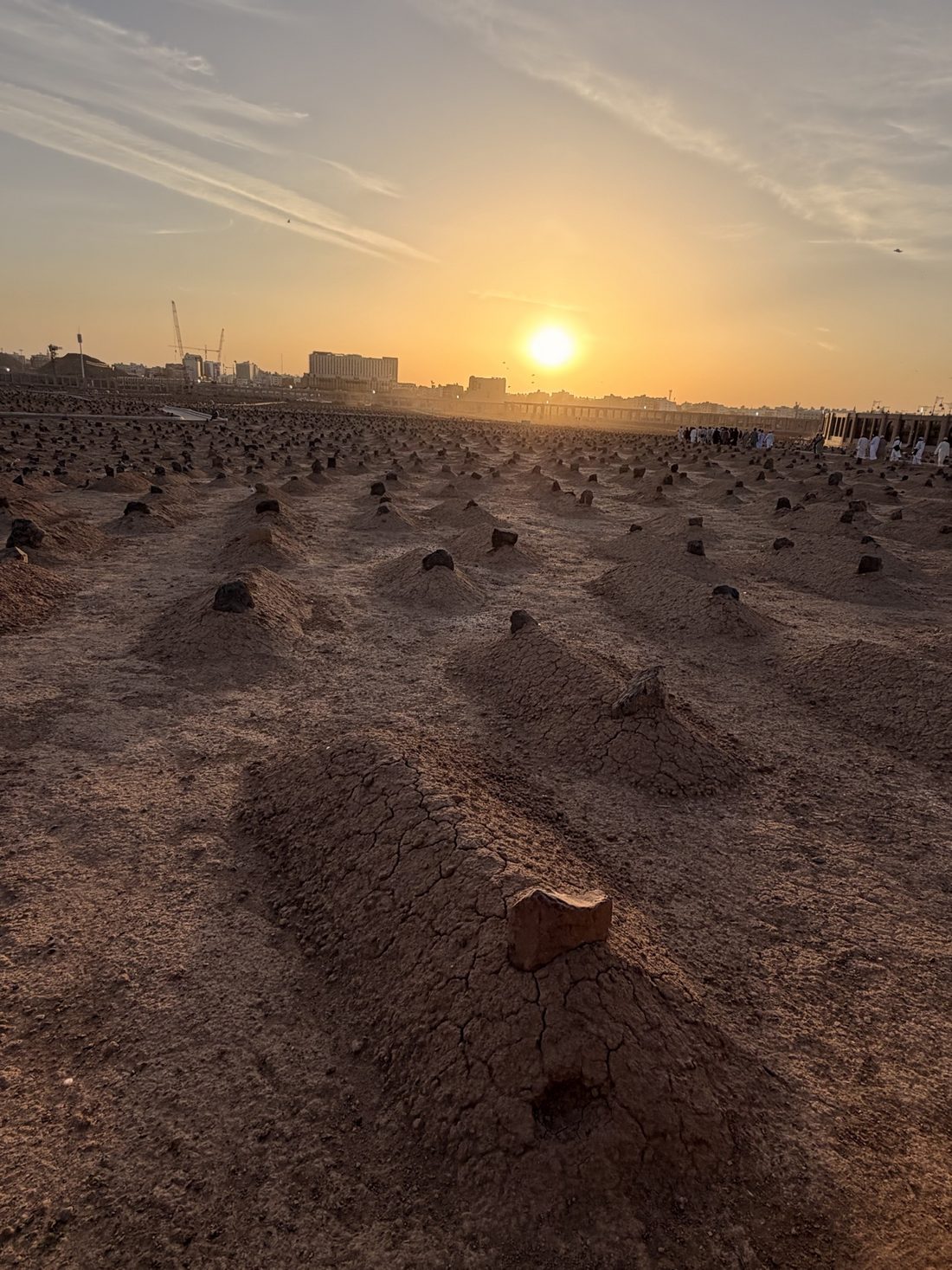 The simple graves of Jannat al-Baqi stretching toward the setting sun